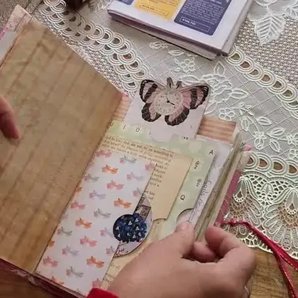 Open journal pages with dyed papers and a butterfly